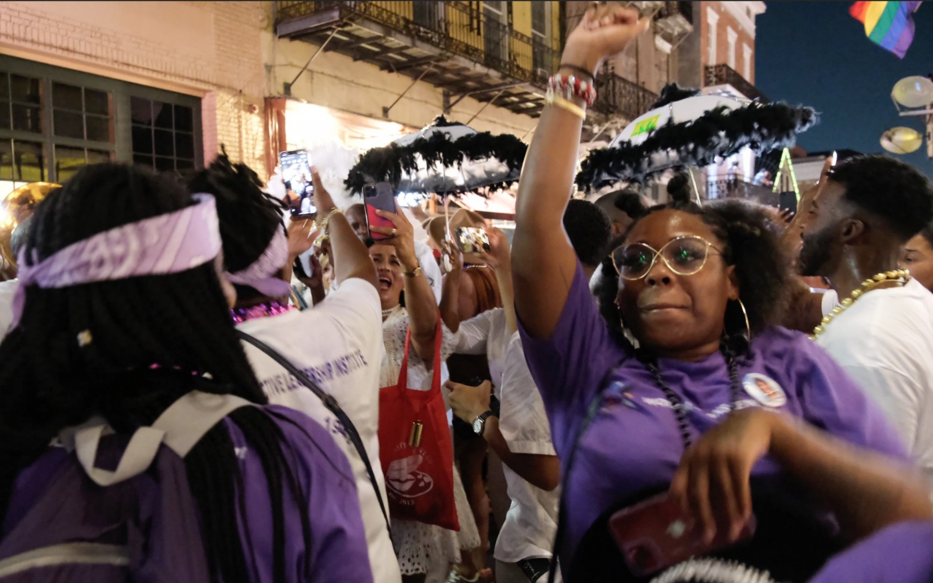Woman with fist in the air on Bourbon Street in New Orleans